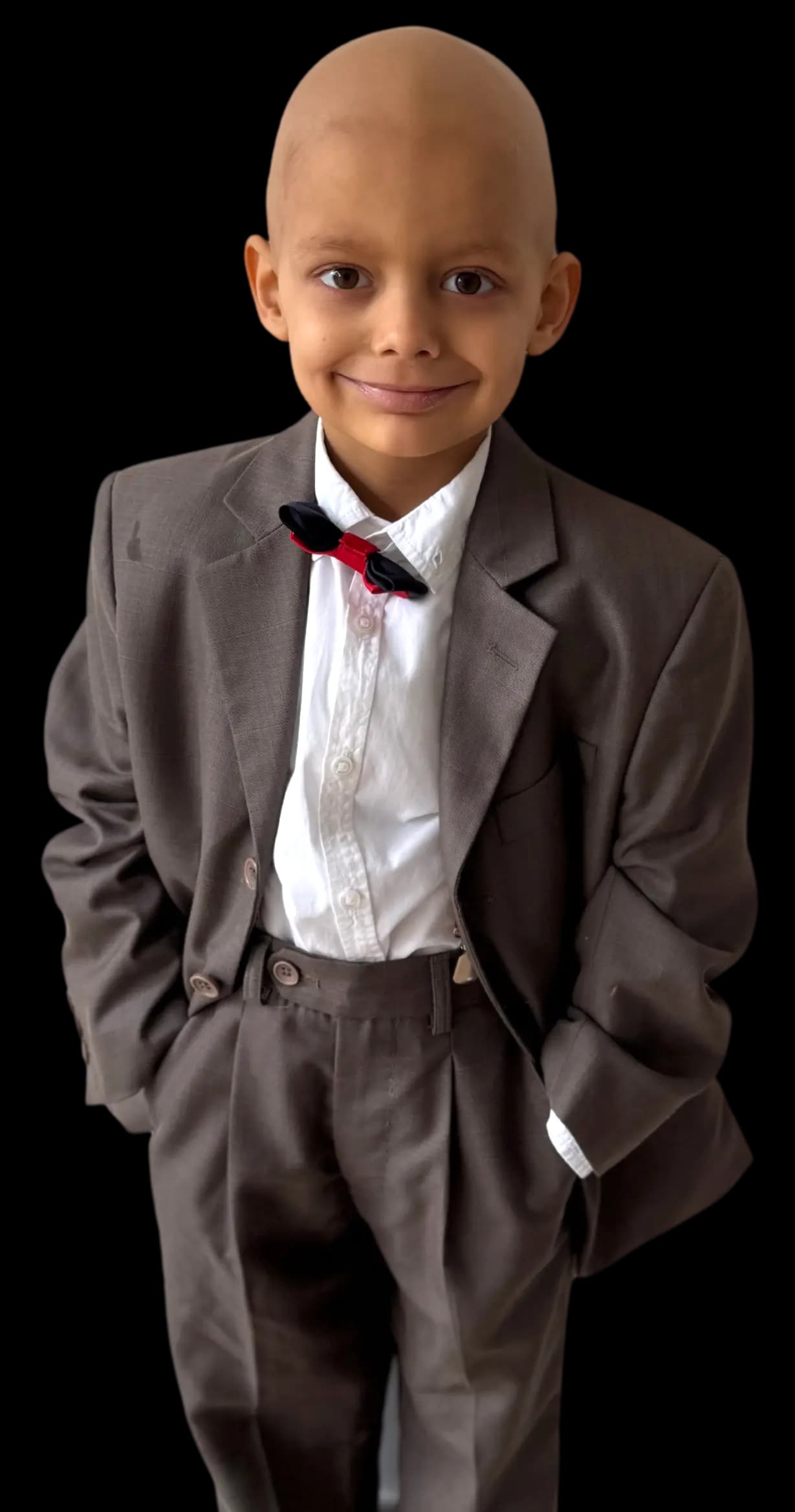 Aleks in a formal suit with a red bow tie