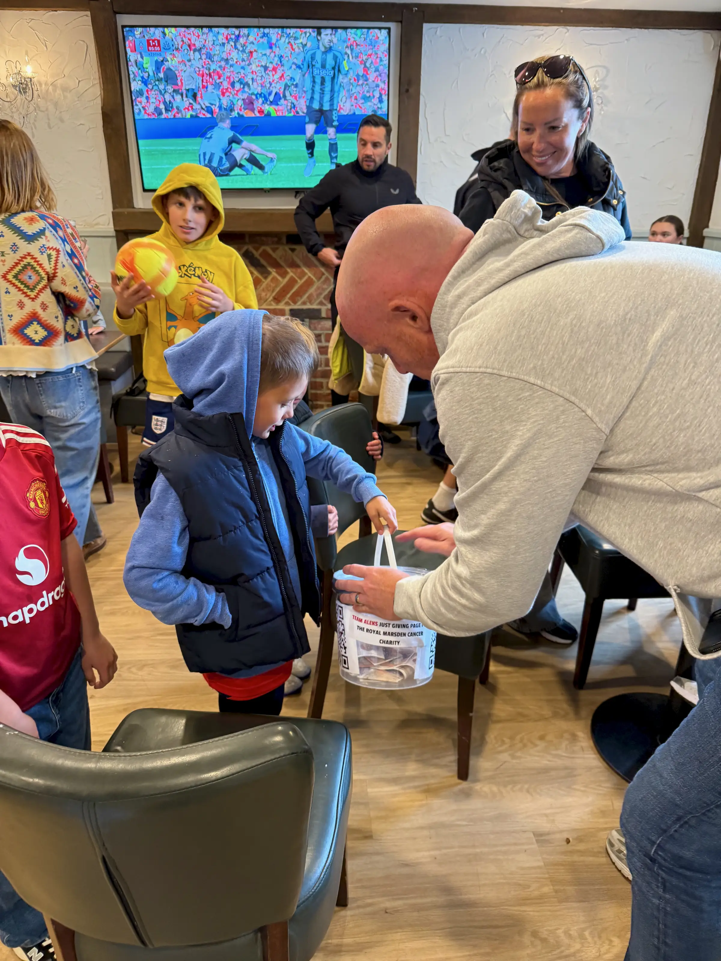 After the final whistle - Aleks walking the collection bucket round the pub, Premier League football on the big screen