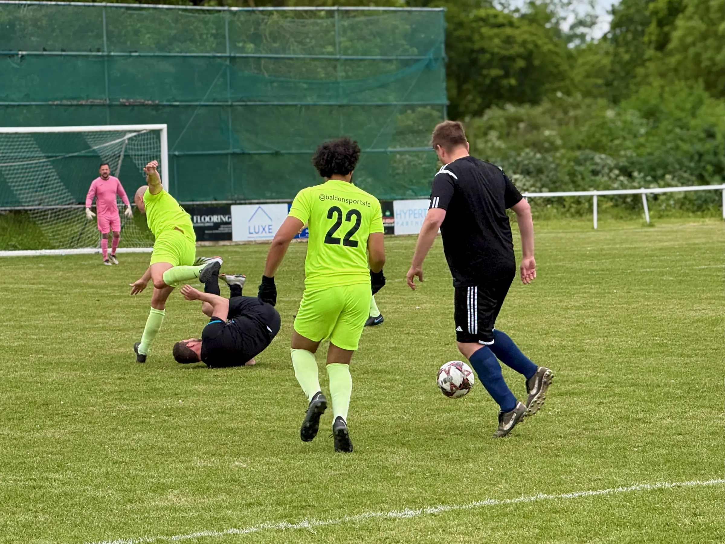 Action in front of the Baldon goal - a Chislehurst attacker goes down as the keeper holds his line