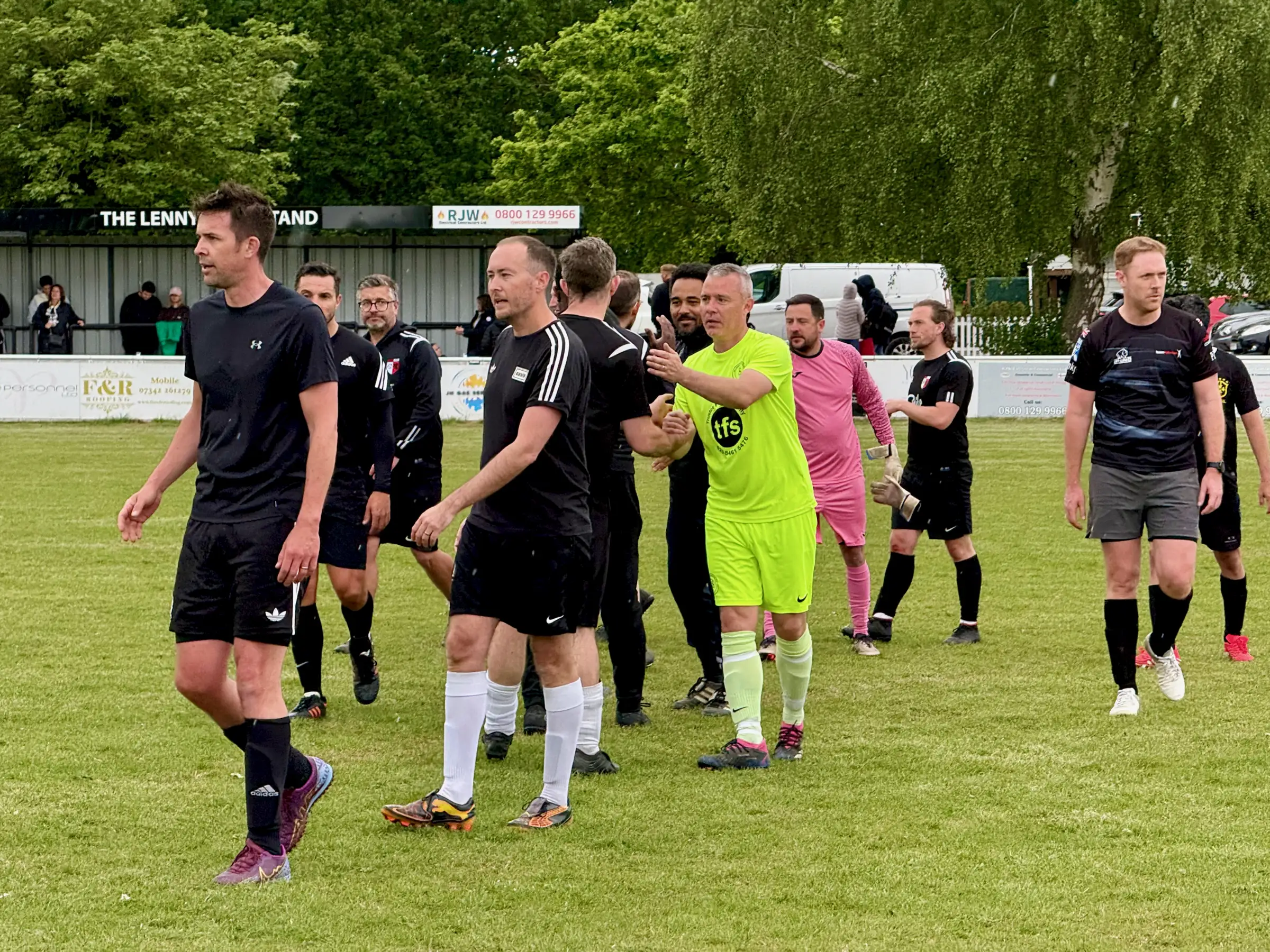 Full time at The Oaks - players from both teams shaking hands. 0-4 on the scoreboard, no losers on the day