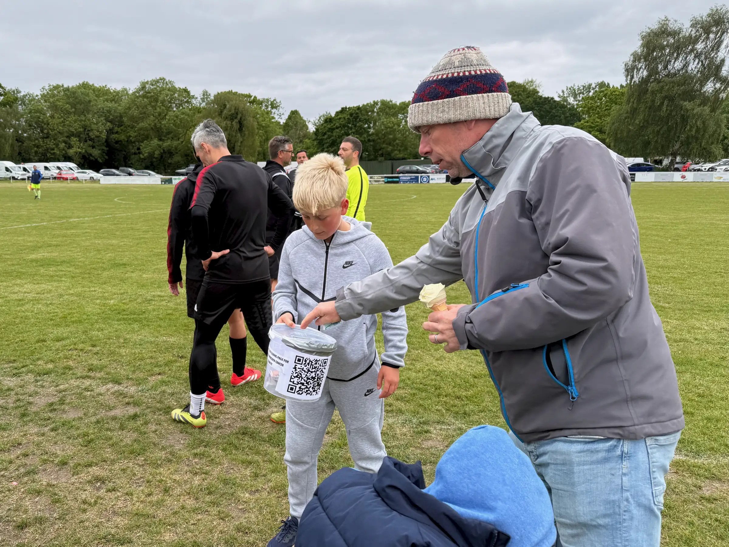 QR-coded collection buckets did the rounds - one of the younger supporters helping out pitchside