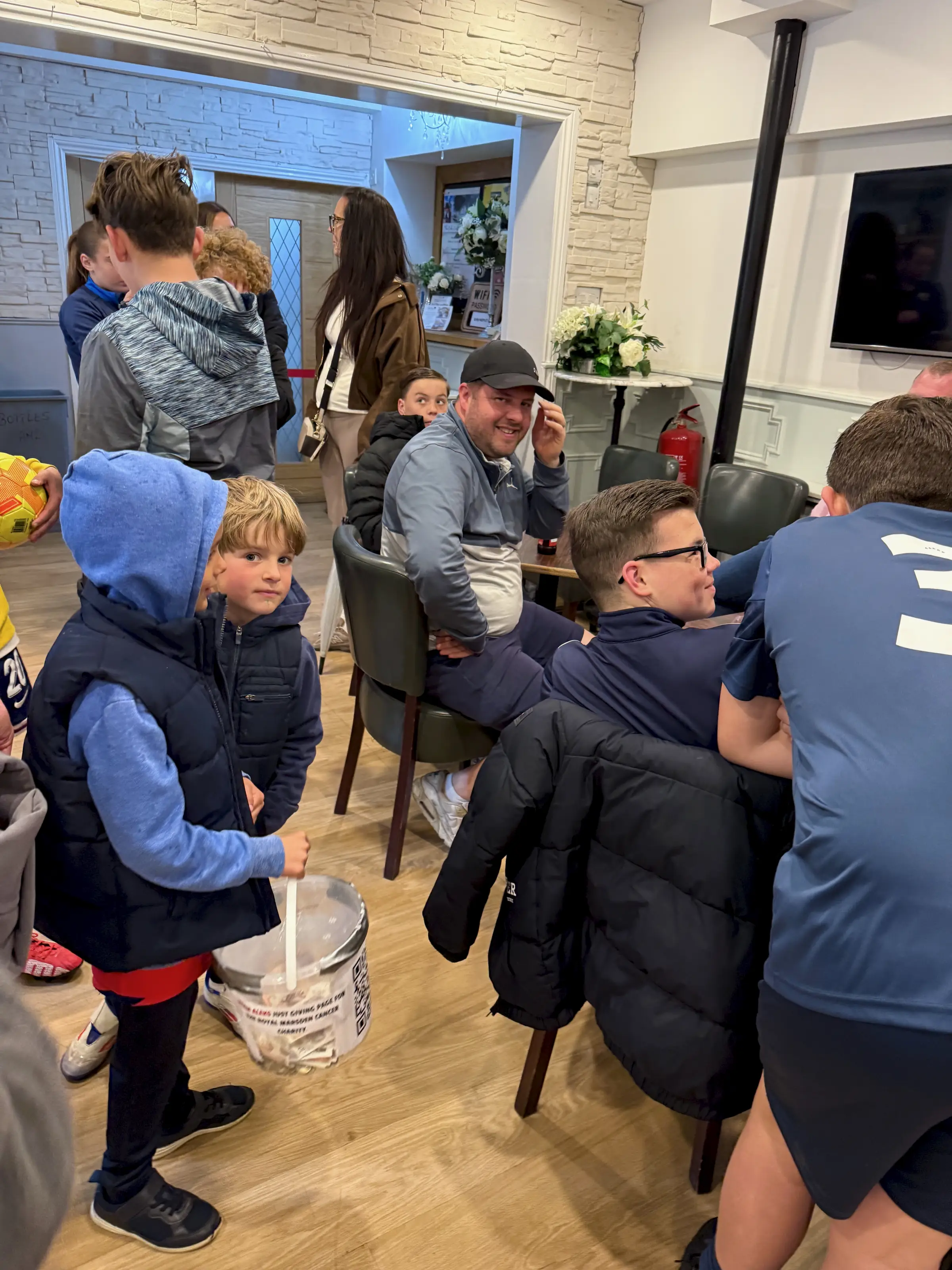 Children gathered round the bucket - the hardest-working fundraisers of the day