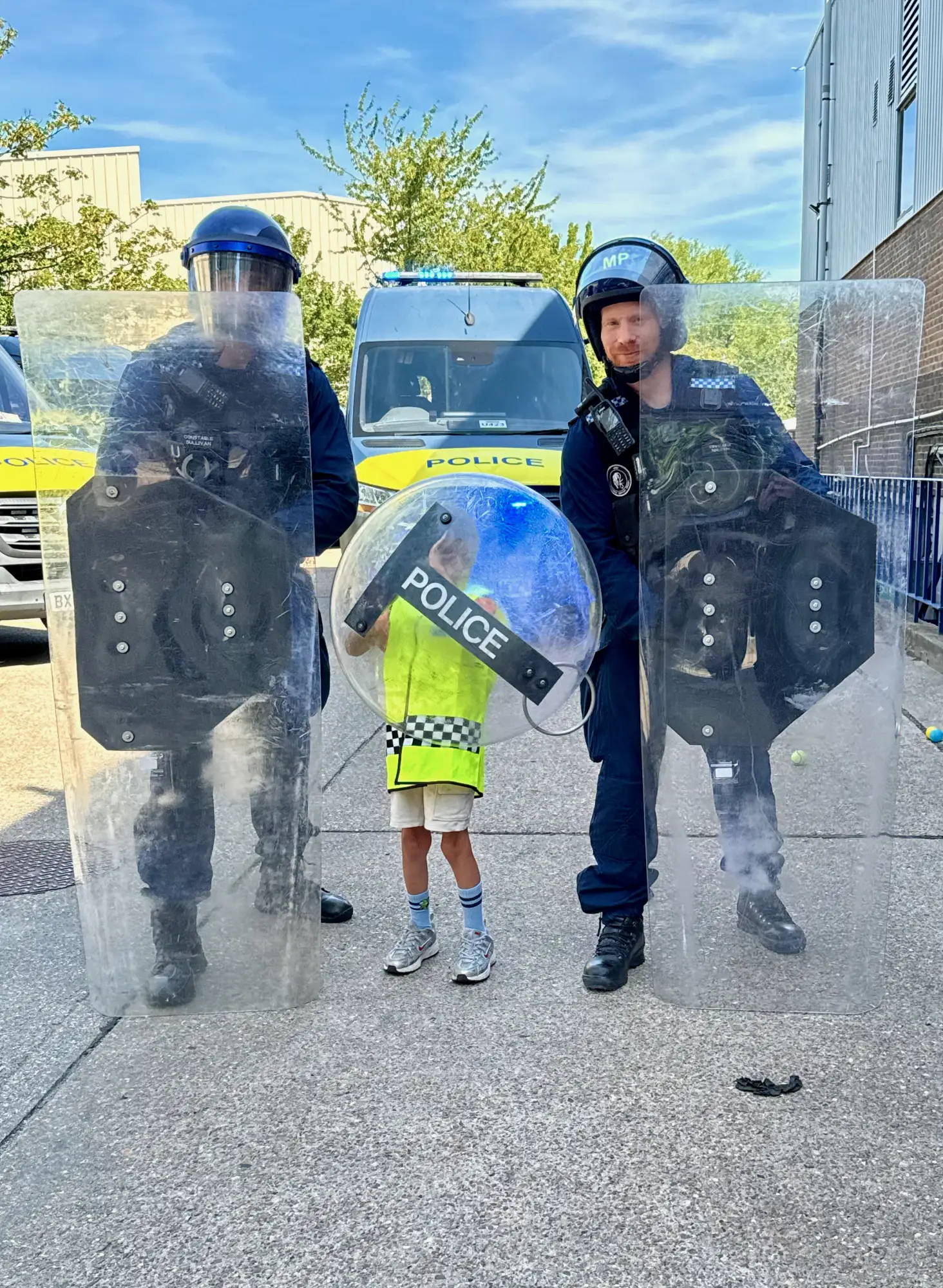 Holding the line behind a public-order shield, flanked by 4TSG.