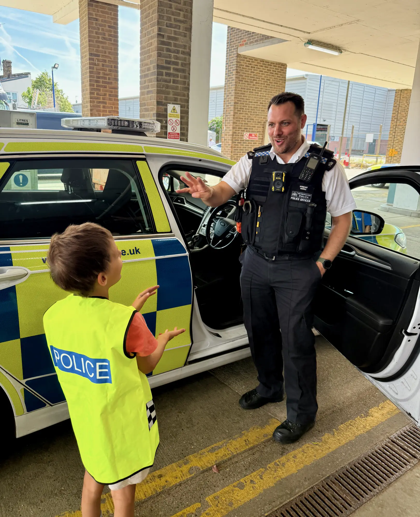 Full of questions, as ever - deep in conversation with one of the officers.