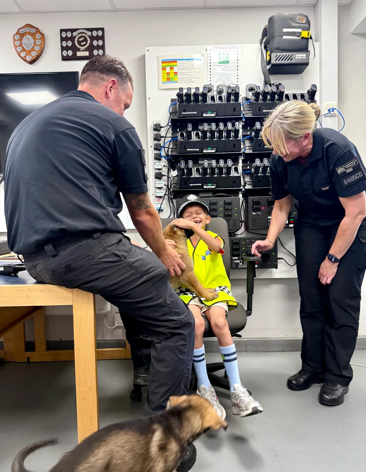 In the Dog Section radio room, Aleks meets two of the youngsters still working through their schooling - all paws, wet noses and pure delight. 🐶