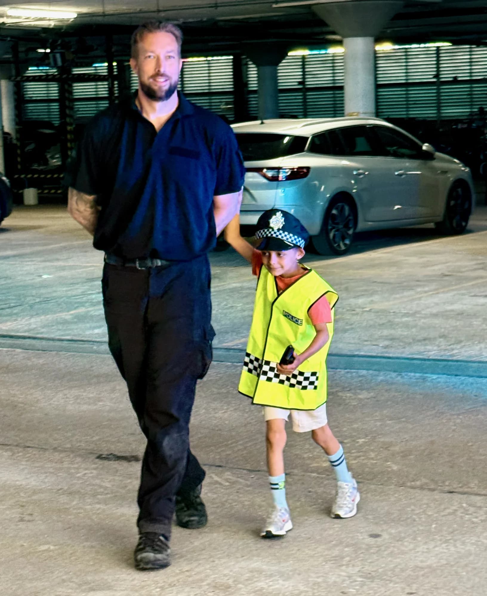 Job done - leading the handcuffed suspect back to the police car.