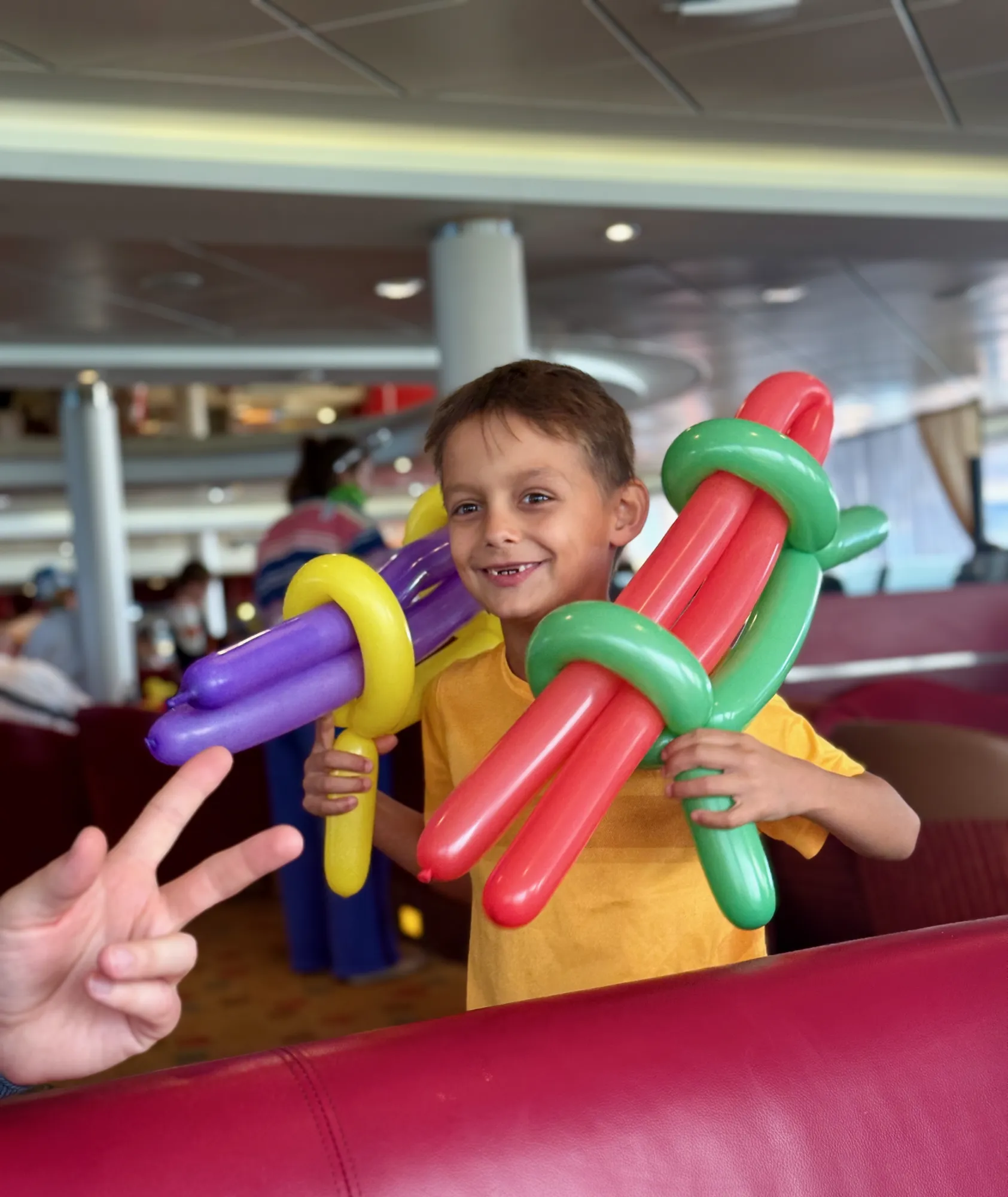 Armed with two balloon guns and an even bigger grin, Aleks joins the rest of the children racing round the ferry on the way home.