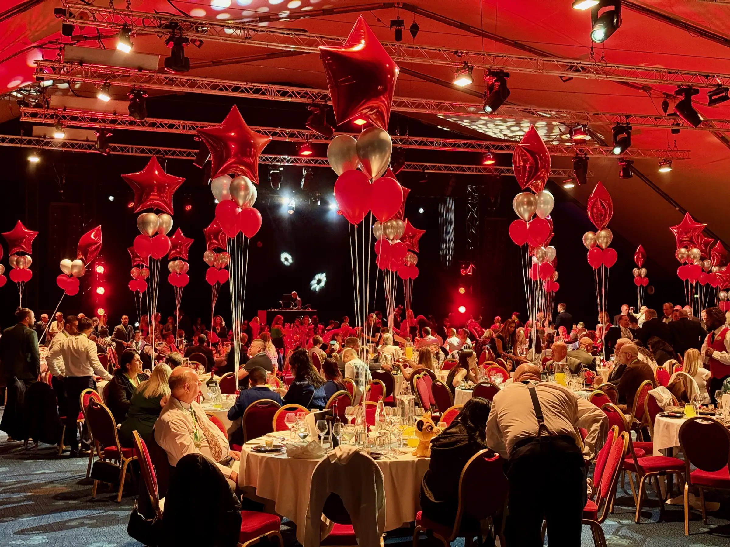 The ball: red stars, balloons and a room full of people dressed to the nines.