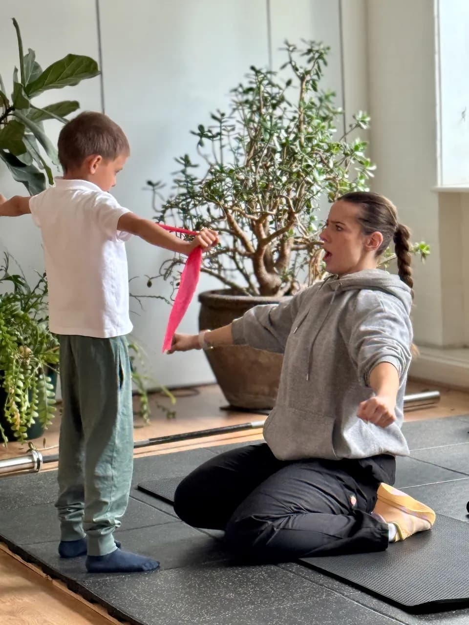 Resistance band work for shoulders and grip - Gabi coaching the tension on each pull, making sure both sides do their share.